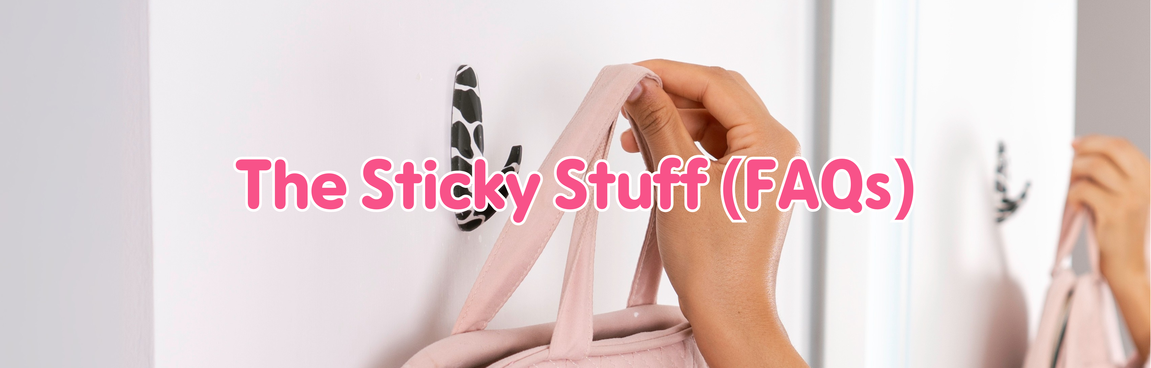 Hand hanging a pink bag on a WallCandy cow print adhesive hook with text overlay “The Sticky Stuff (FAQs).