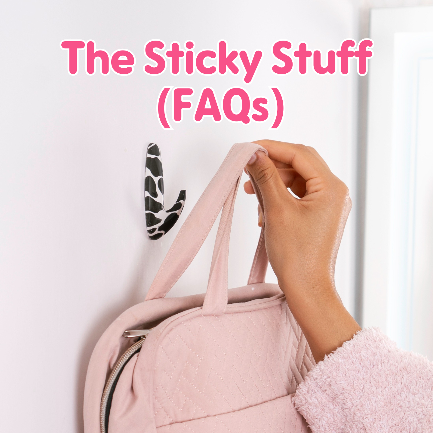 Hand hanging a pink bag on a WallCandy cow print adhesive hook with text overlay “The Sticky Stuff (FAQs).