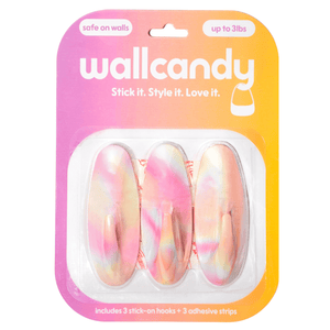 Packaged wall hooks with colorful design on a gradient pink and orange background, featuring the brand 'wallcandy'.