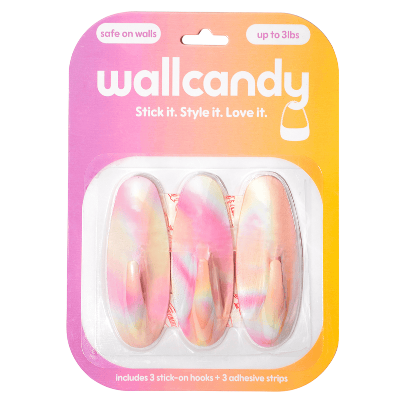 Packaged wall hooks with colorful design on a gradient pink and orange background, featuring the brand 'wallcandy'.